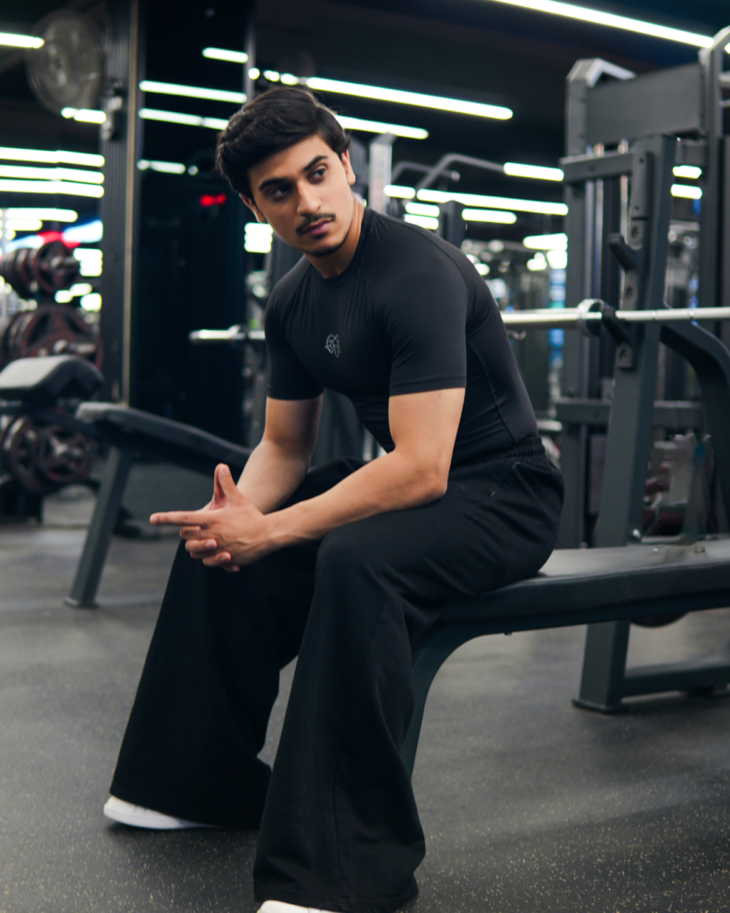 Young Goat black compression t-shirt lifestyle — men sitting in gym, India