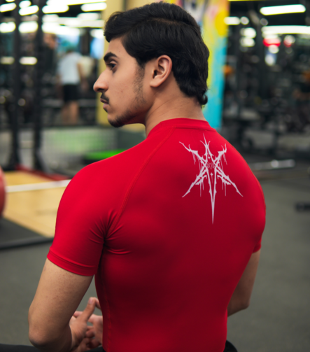Young Goat red compression t-shirt back graphic seated in gym — men's compression wear India
